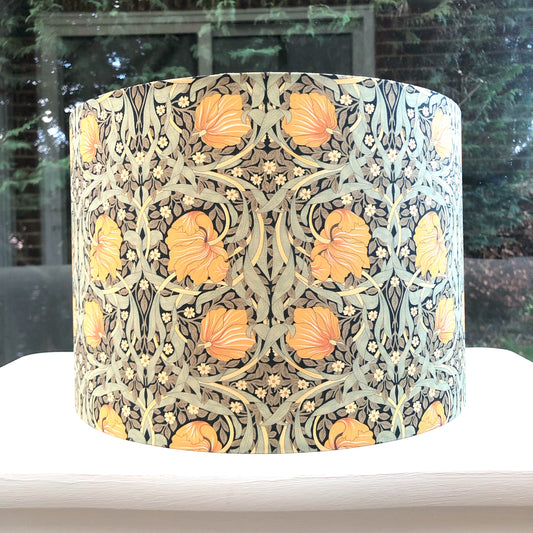 Green and mustard floral patterned lampshade, infusing spaces with vibrant and cozy lighting ambiance.