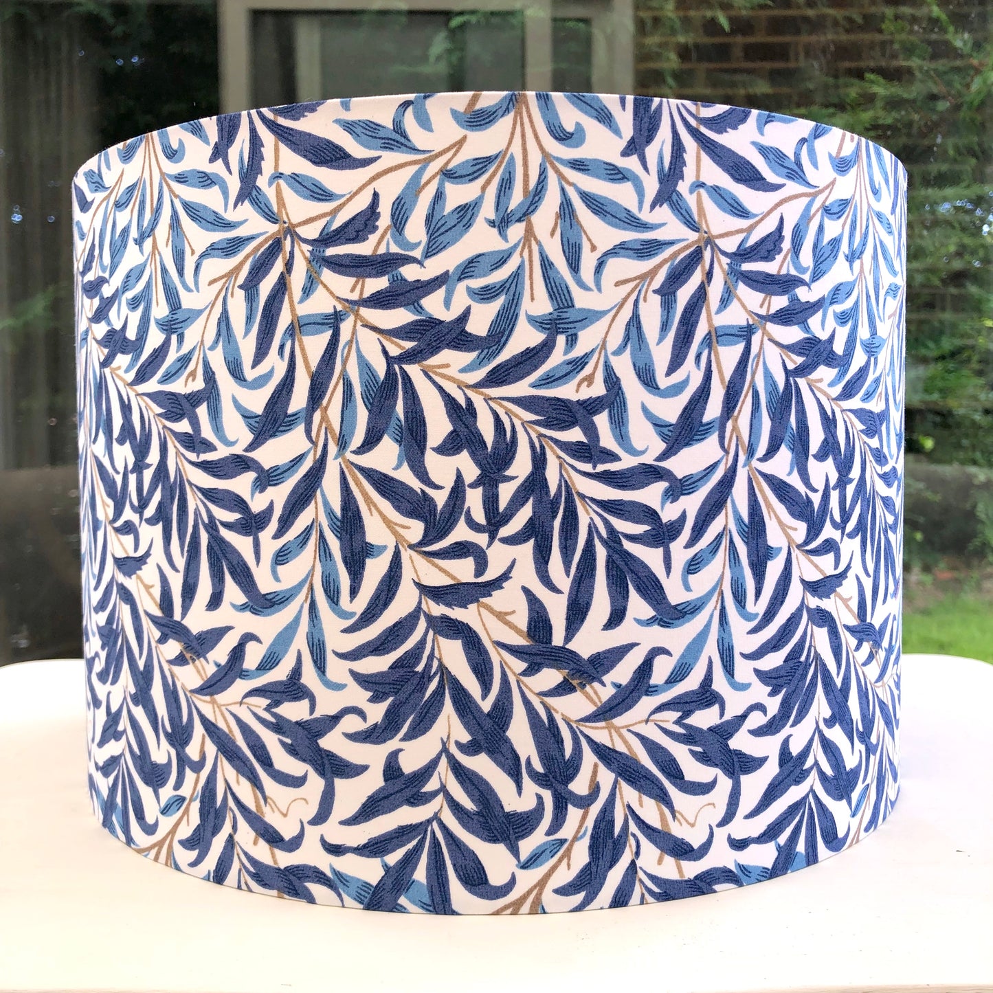 Blue lampshade featuring a delicate willow bough pattern, offering a serene and nature-inspired ambiance.