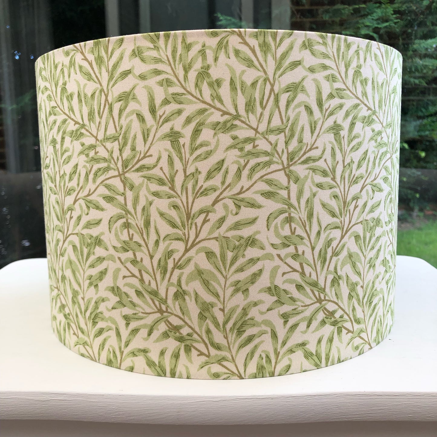 Green coloured lampshade featuring a delicate willow bough pattern, offering a serene and nature-inspired ambiance.