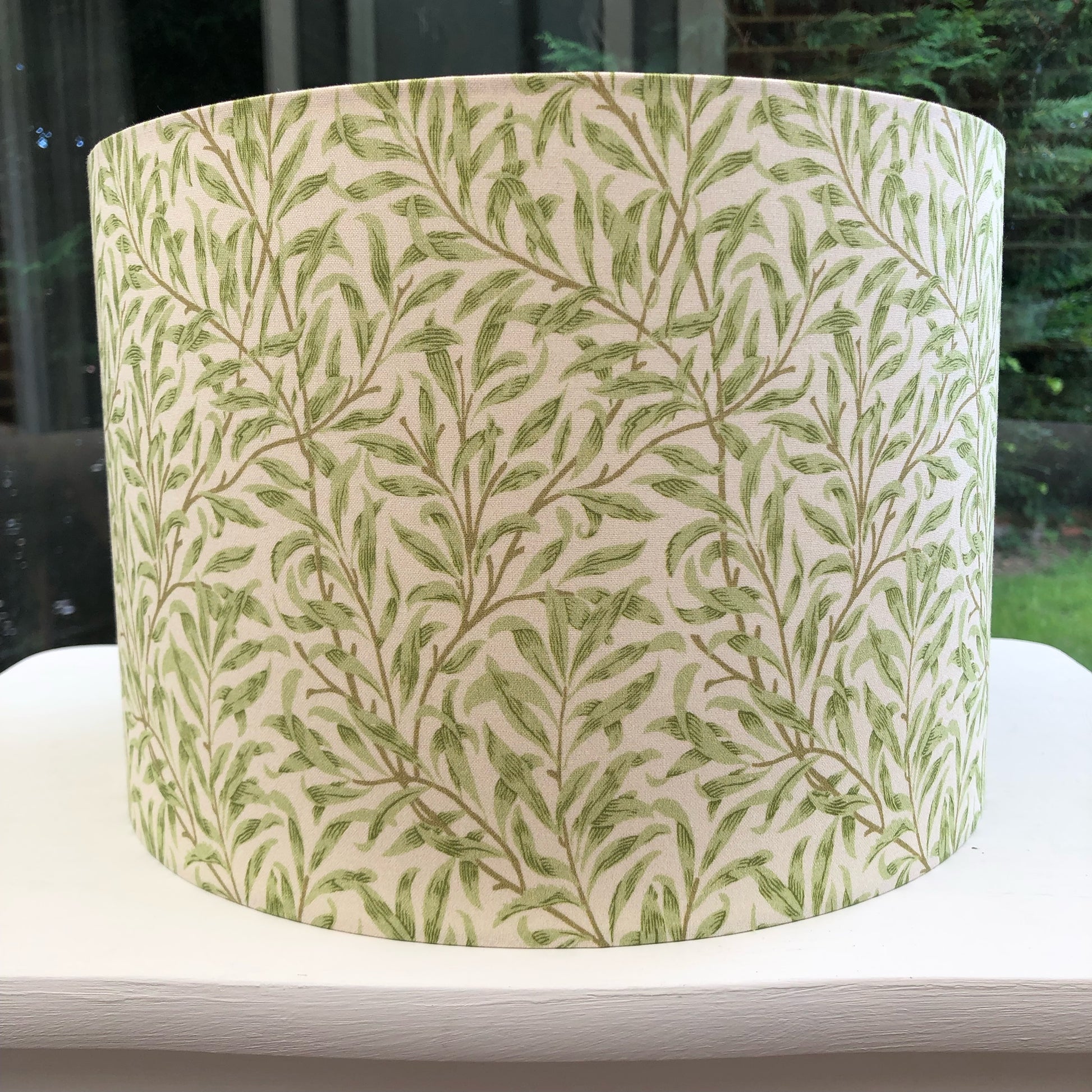 Green coloured lampshade featuring a delicate willow bough pattern, offering a serene and nature-inspired ambiance.