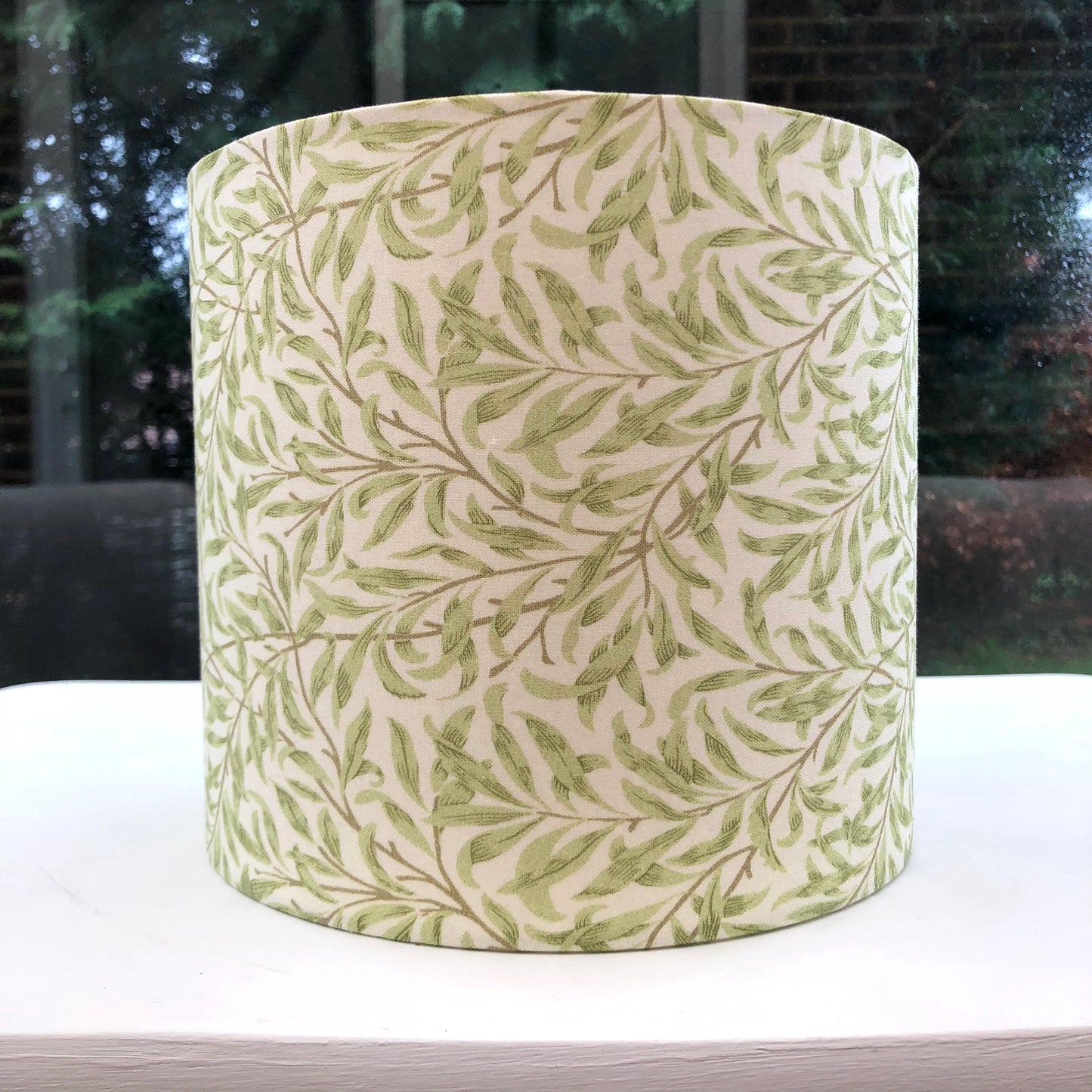 Green coloured lampshade featuring a delicate willow bough pattern, offering a serene and nature-inspired ambiance.