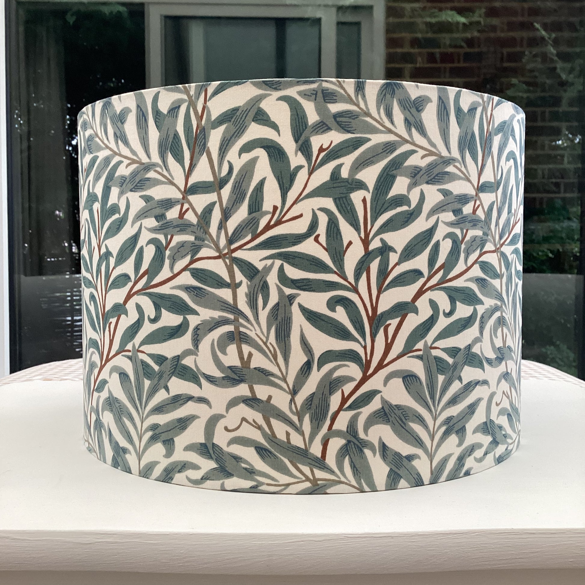 Green gray coloured lampshade featuring a delicate willow bough pattern, offering a serene and nature-inspired ambiance.