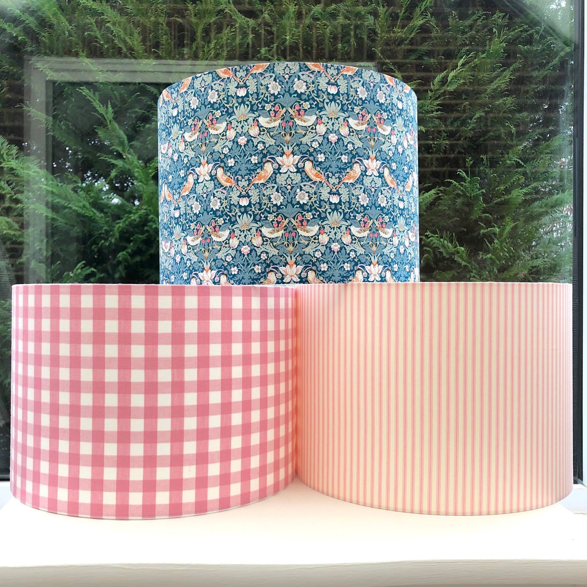 Pink coloured gingham-patterned lampshade, adding a touch of rustic charm to any space.