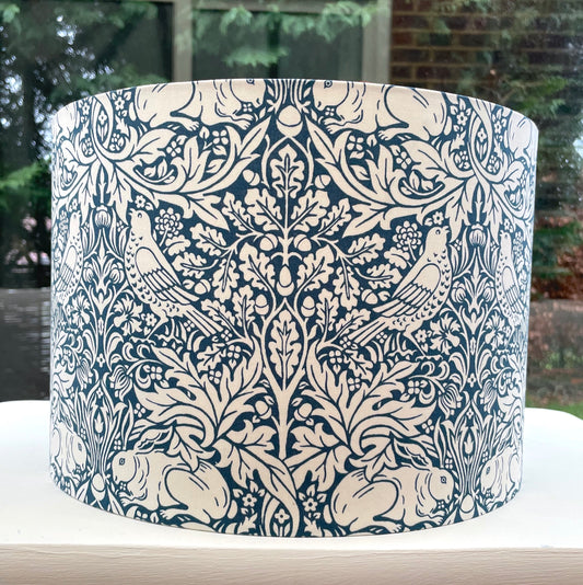 William Morris Brer Rabbit lampshade in navy blue with detailed floral and animal motifs, perfect for adding a vintage, artistic touch to any room.