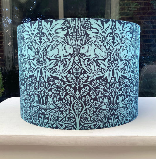 William Morris Brer Rabbit fabric lampshade in navy and teal, showcasing intricate floral and animal motifs, perfect for adding a vintage-inspired touch to your home decor.