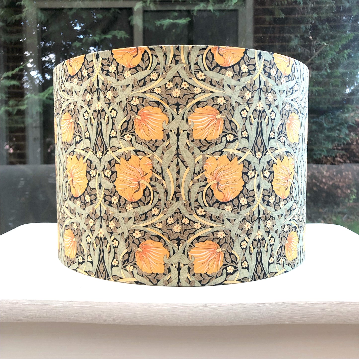 Green and mustard floral patterned lampshade, infusing spaces with vibrant and cozy lighting ambiance.