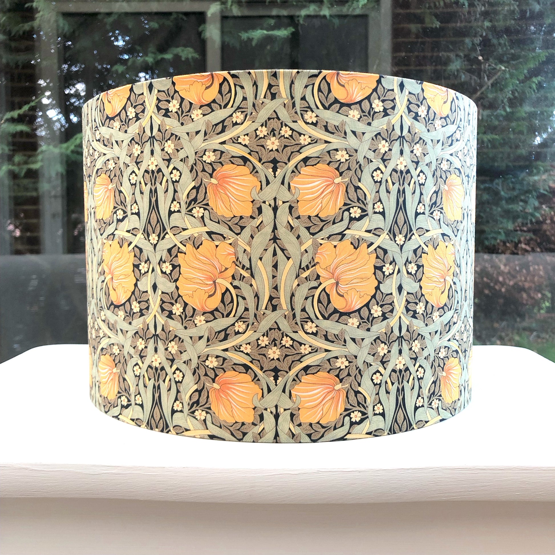 Green and mustard floral patterned lampshade, infusing spaces with vibrant and cozy lighting ambiance.