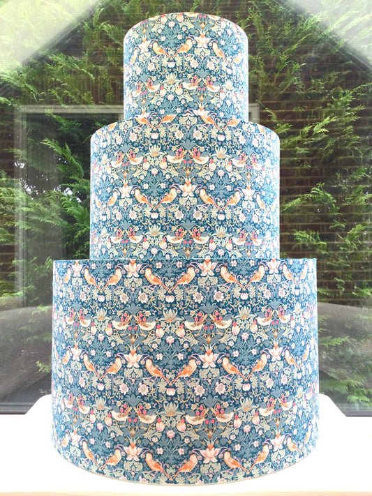 William Morris Strawberry Thief lampshade in green, blue, and pink, showcasing a vintage floral design. Perfect for adding a touch of classic elegance to any room decor.