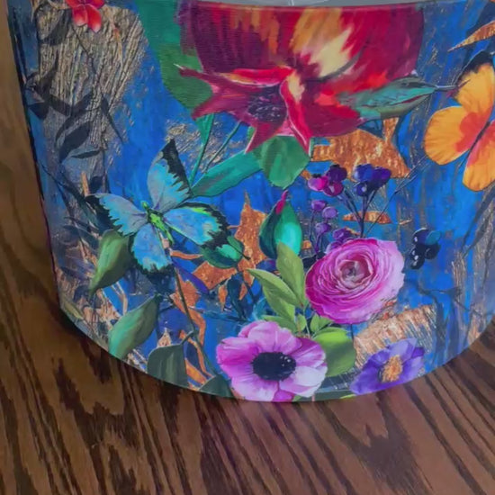 A luxurious blue velvet lampshade with a soft, plush texture and a warm, inviting glow, adding a touch of sophistication to any room.