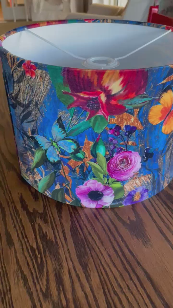 A luxurious blue velvet lampshade with a soft, plush texture and a warm, inviting glow, adding a touch of sophistication to any room.